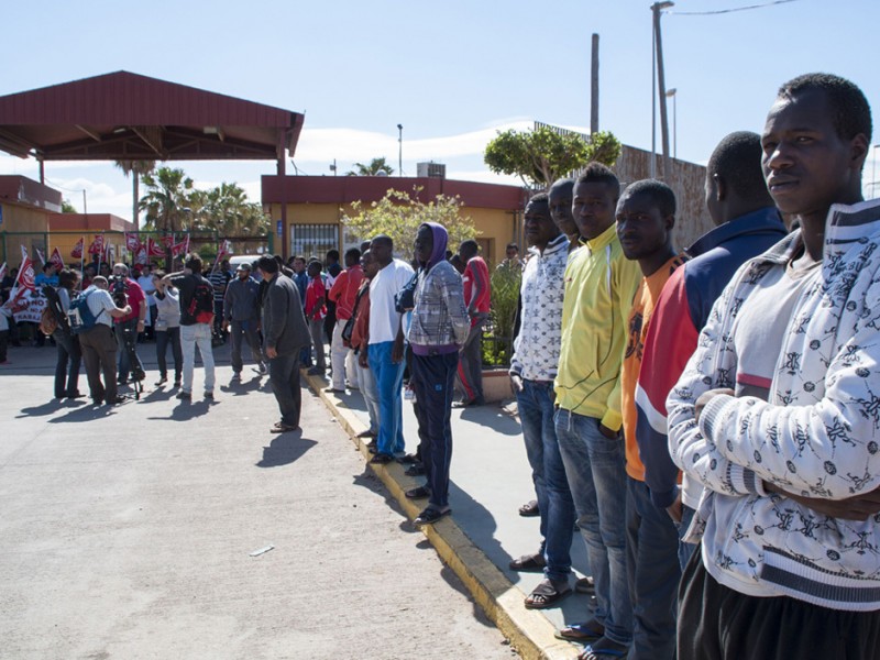 Would-be immigrants stand outside the Centre for Temporary Stay of Immigrants (CETI), following a morning assault in Melilla, on May 28, 2014. About 500 African migrants leapt a towering, triple-layer border fence to cross from Morocco to the tiny Spanish territory of Melilla today, one of the biggest breaches in nearly a decade, officials said.  AFP PHOTO/ JESUS BLASQUEZJESUS BLASQUEZ/AFP/Getty Images