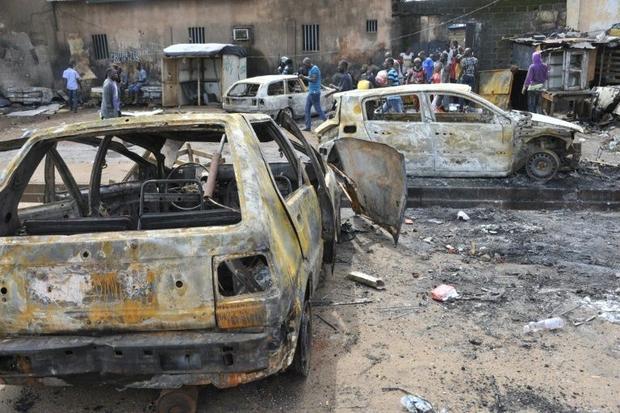  People walk past destroyed cars in Conakry on October 9, 2015, after at least two people were killed and scores hurt in clashes between rival political parties ahead of Guinea's presidential election Cellou Binani, AFP  Read more: http://www.digitaljournal.com/news/world/tension-flares-in-guinea-ahead-of-presidential-poll
