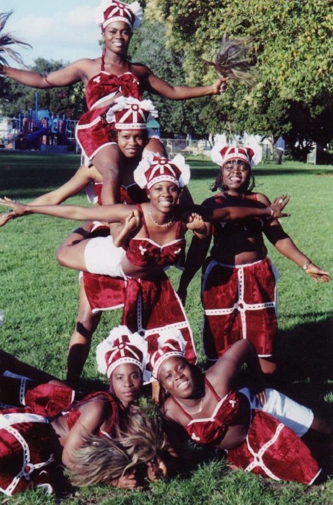 A group of people in red and white outfits.