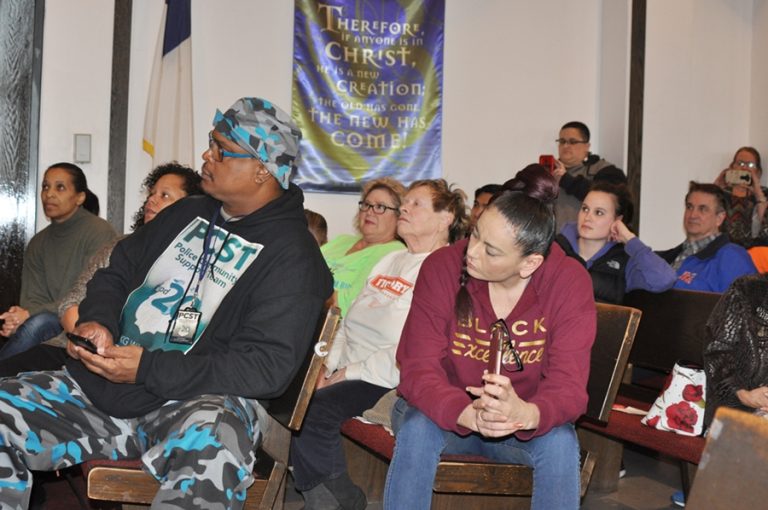 A group of people sitting in chairs at a conference.