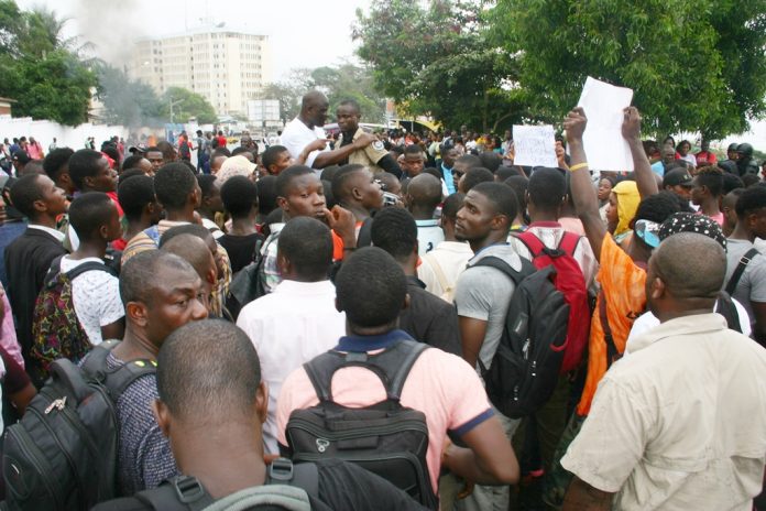 A group of people standing around each other.