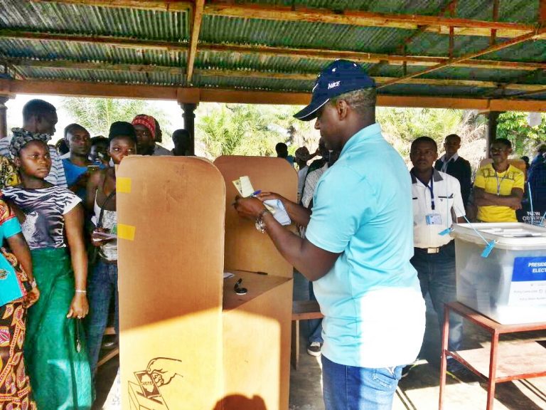 A man standing in front of a box.