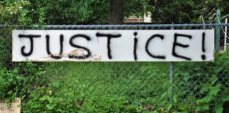 A fence with the word justice written on it.